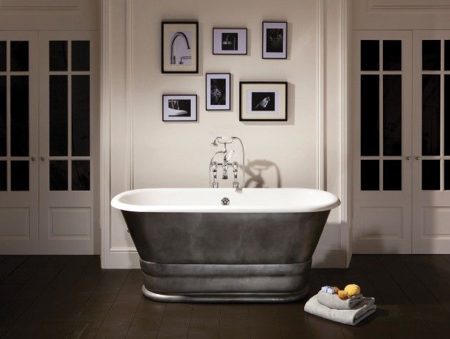 white and grey free standing bath in room with wooden floor