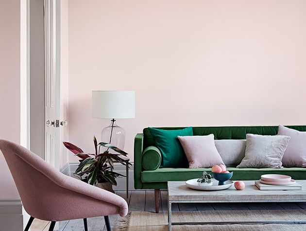 light pink room with green sofa
