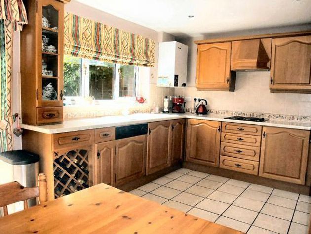 Open plan kitchen diner with island unit and window seat before 4