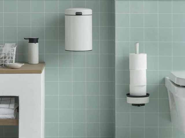 Brabantia white wallmounted bathroom accessories in a small teal tile bathroom