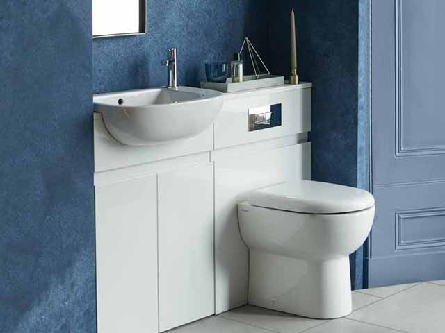 compact white basin and toilet in a small blue bathroom by britton
