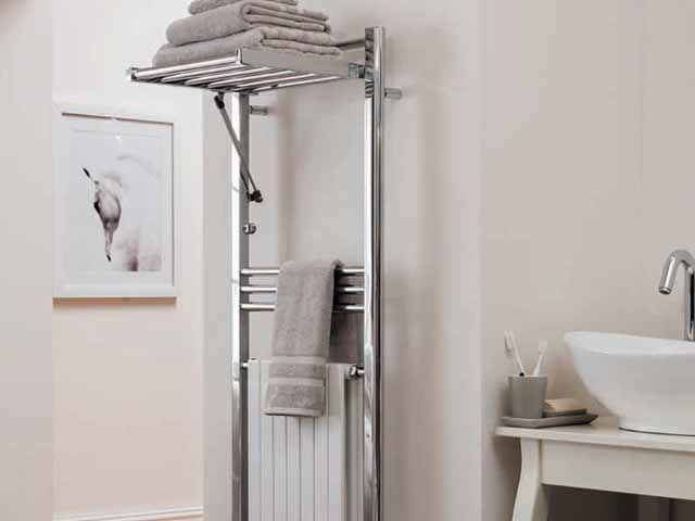 duonique towel warmer rails by aestus in a modern neutral cream and grey decorated bathroom