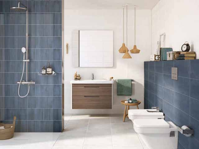 a wall mounted white sink unit with wood drawer in a blue modern bathroom 