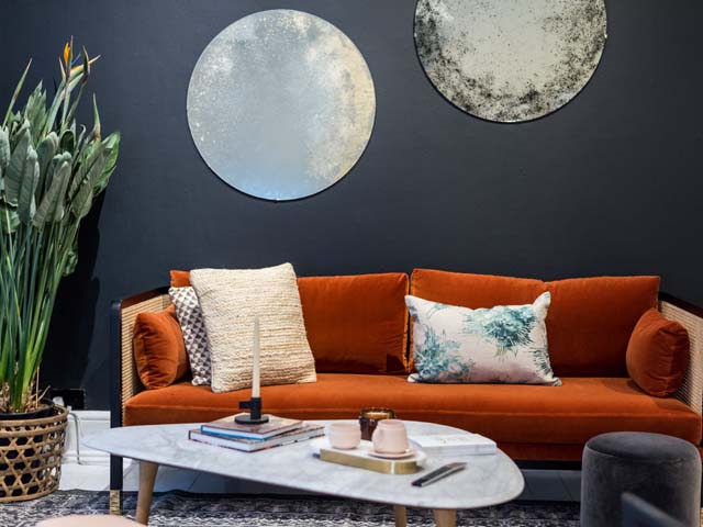 70s trend in the living room with an orange velvet sofa at Houzz of 2018