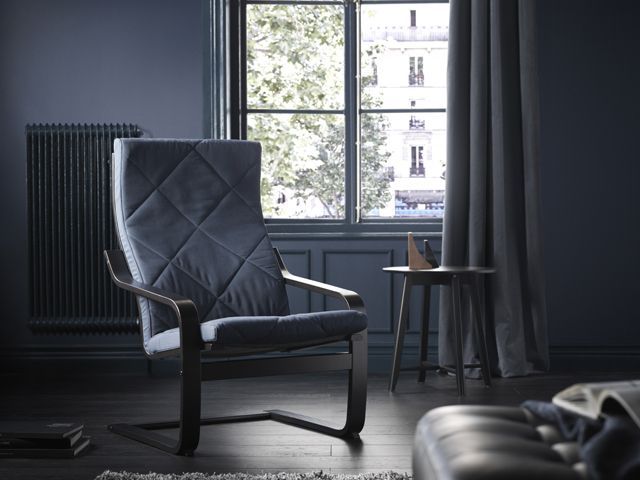 dark leather poang chair by Ikea in a dark room