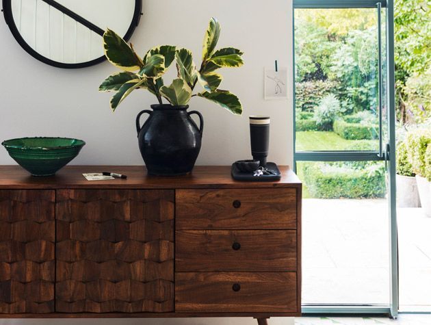 pared back style living room corner with natural wood cabinet