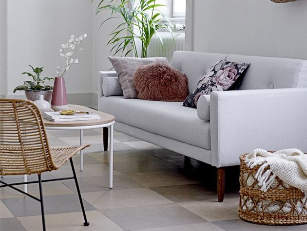 pared back style living room with light grey sofa wicker chairs and wicker basket