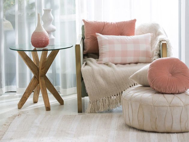 pared back style living room with mint green arm chair and blush pink cushions