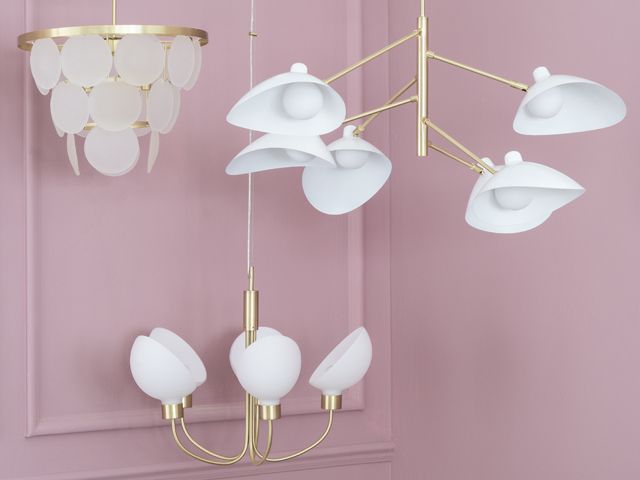  a selection of gold brass pendant statement lighting by bhs spring summer 2018 collection in front of a pink wall