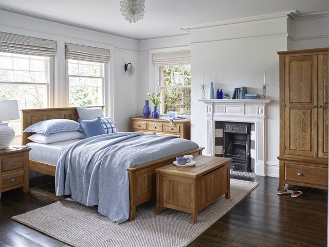 taunton classic wood furniture in a blue bedroom by oak furnitureland