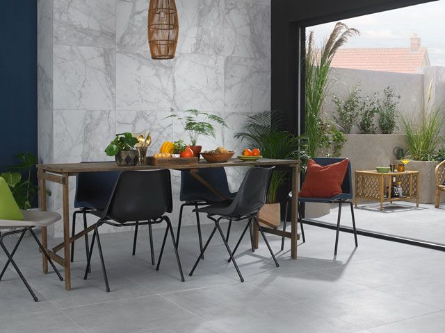 grey marble tiles on dark blue walls in a dining room from the new coracle collection from Walls and Floors