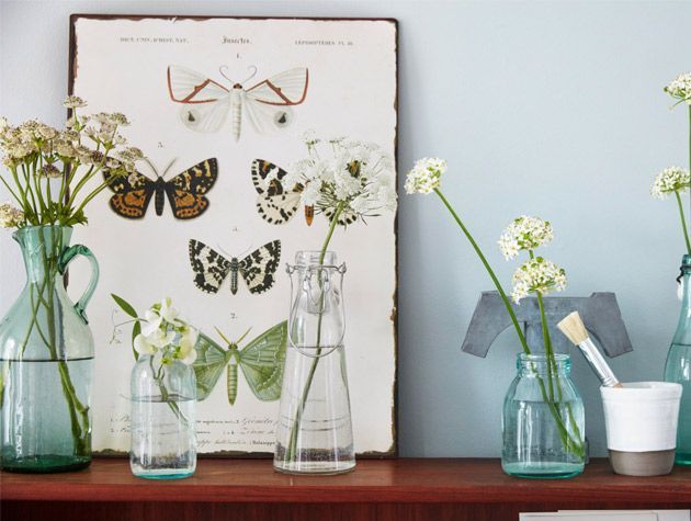 bedside cabinet with decorative flowers and butterfly wall framed print