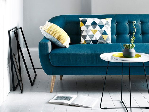 blue sofa in livingroom with geometric cushions