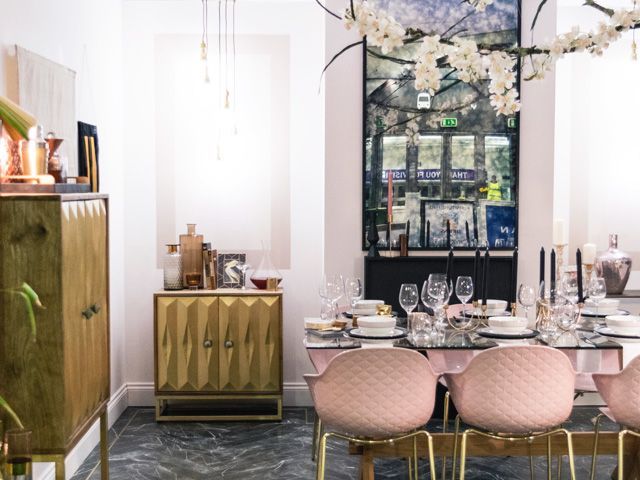 pink chairs, statement lighting and gold furniture in the dining room at good homes roomsets at ideal home show 2018