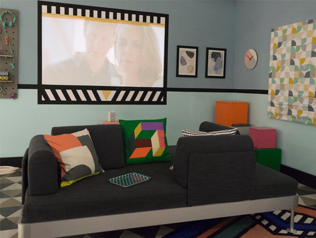 geometric print cushiona on grey sofa in multimedia room