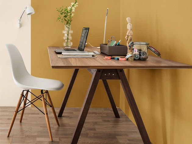 mustard and cream room with desk and laptop