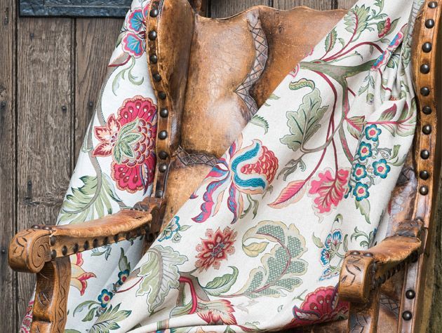 floral fabric draped over copper arm chair
