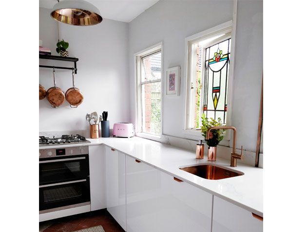 u shaped white decor kitchen with copper accents and copper utensils