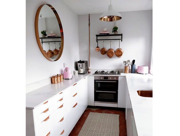 u shaped white decorated kitchen with copper accents and copper utensils