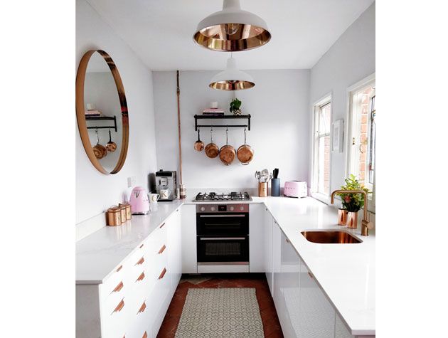 u shaped white kitchen with copper accents and copper utensils