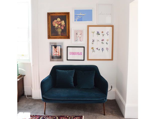 gallery wall with wall art and teal velvet armchair