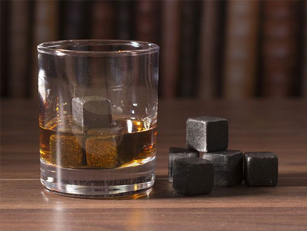 glass of whiskey with whiskey cooling rocks in the glass from creative tops
