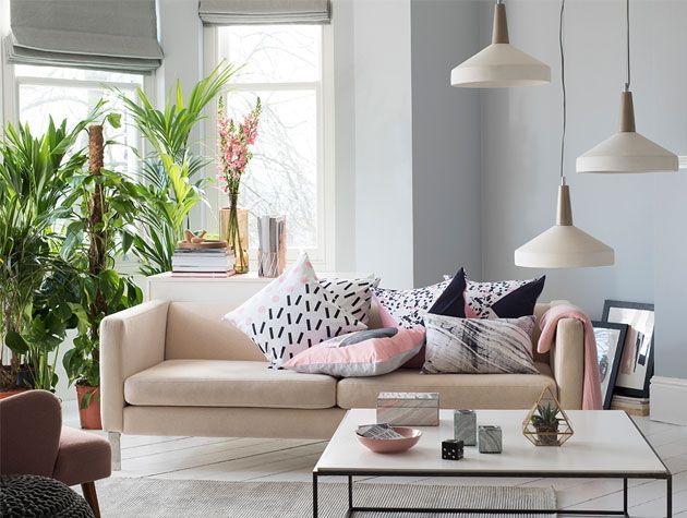 living room withbhs lighting beige sofa and geometric cushions