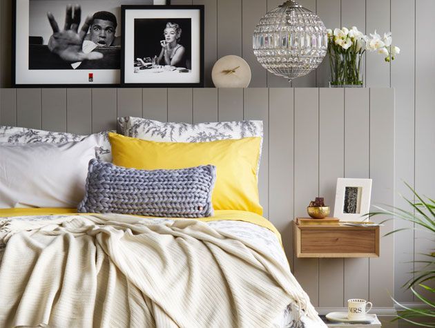 yellow and grey scheme bedroom with framed prints above bed bhs