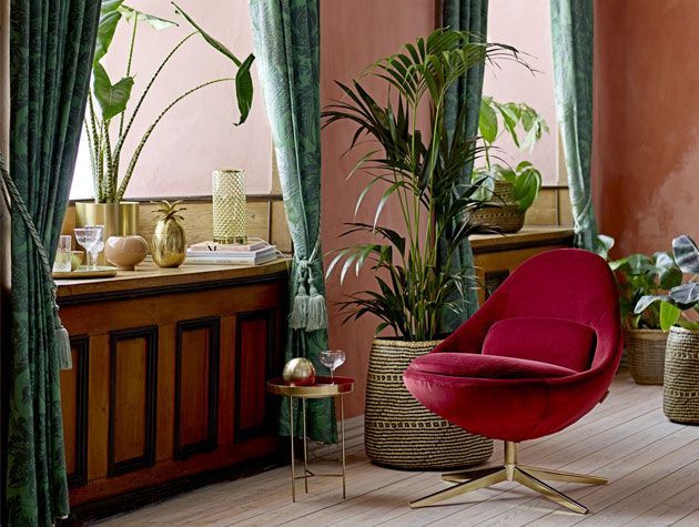 botanical living area with plush red velvet arm chair with earthy colour themed decor