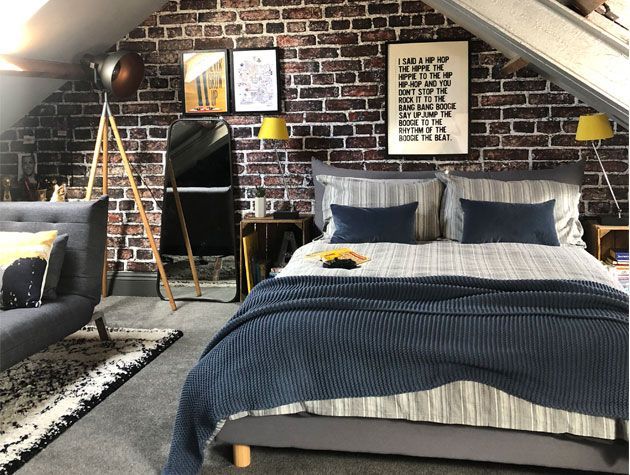 boys bedroom with brick wall grey carpet and blue grey bedding