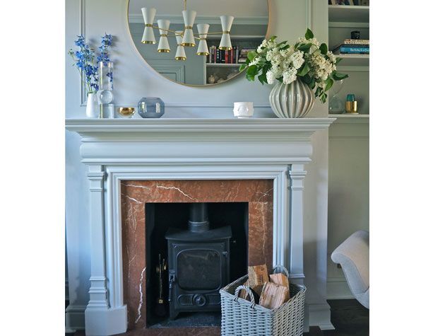 brown and white marble fire place with flowers on mantlepiece