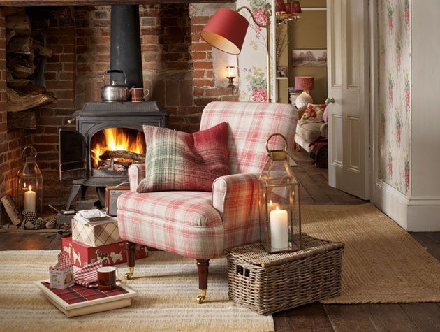 cosy living room with open fire floral wallpaper red arm chair