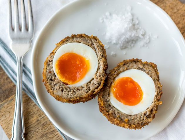 homemade scotch eggs served on white plate