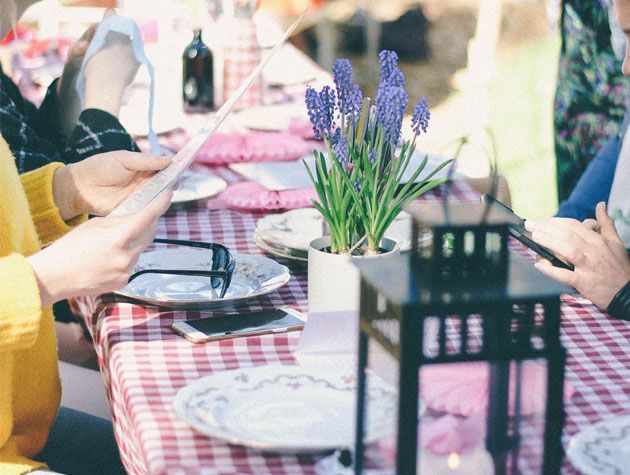 outdoor dining table with red and white gingham table cloth and decorative lavender