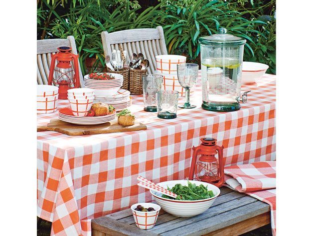 outdoor garden dining table with red andwhite gingham table cloth al fresco