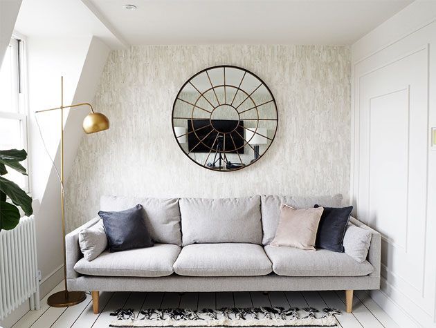 stone grey three seater sofa in biege and white decor living room with copper floor lamp