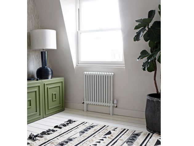 tv room with beige walls olive green tv unit monochrome rug and window