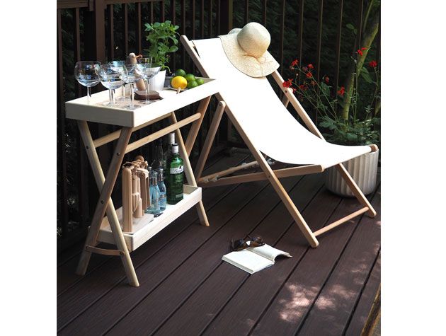 drinks trolly and biege sun lounger on dark brown wooden decking