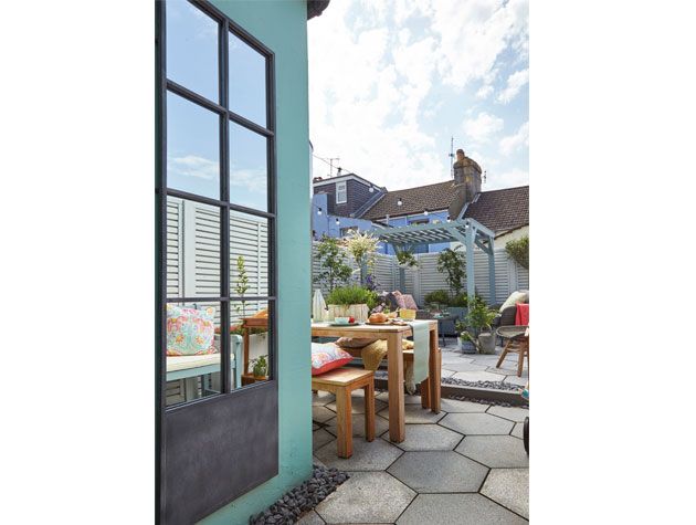 Large mirror hanging on garden wall - garden-goodhomesmagazine.com