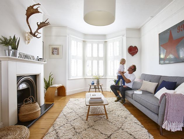 modren victorian style living room with fireplace and stag skull hung above