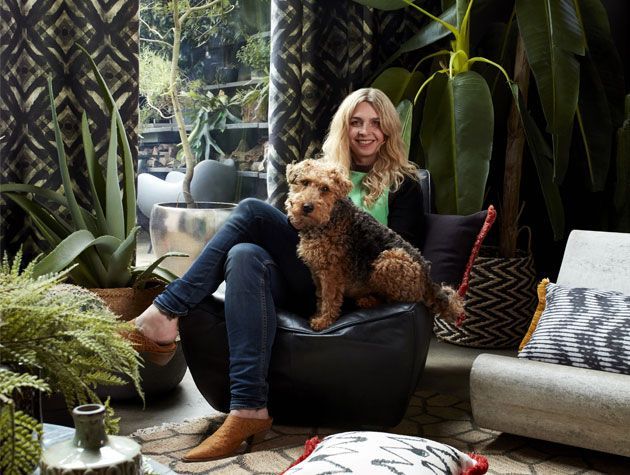 Abgail Ahern sat in a living room with her dog for her Hillarys curtain Roman blind collaboration -living-room-goodhomesmagazine.com