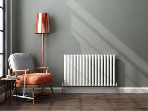 reading corner with silver and orange chair, modern radiator and copper lamp by soak.com - living room - goodhomesmagazine.com