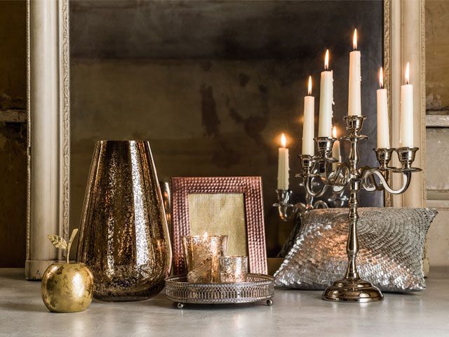Gothic candle holder, brass vase, apple ornament and gold trinkets for mantle piece -tesco-living-room-goodhomesmagazine.com