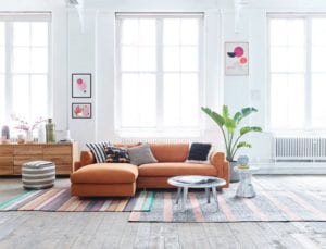Large living room with tan sofa and layered multi coloured stripe rugs -habitat-living-room-goodhomesmagazine.com