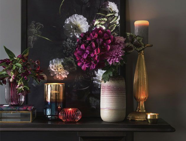 Mantle piece decorated with display of flowers, vases and candles -amara-living-room-goodhomesmagazine.com
