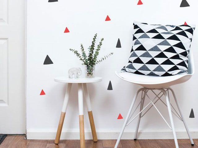 Orange grey wall stickers in hallway with chair and geometric cushion -etsy-wall-boss-living-room-goodhomesmagazine.com