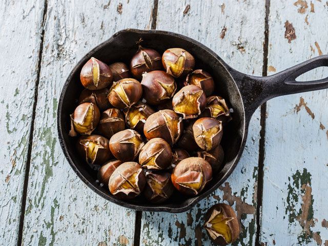 Pan roasted chestnuts placed on an outdoor table -the-art-of-hygge-kitchen-goodhomesmagazine.com
