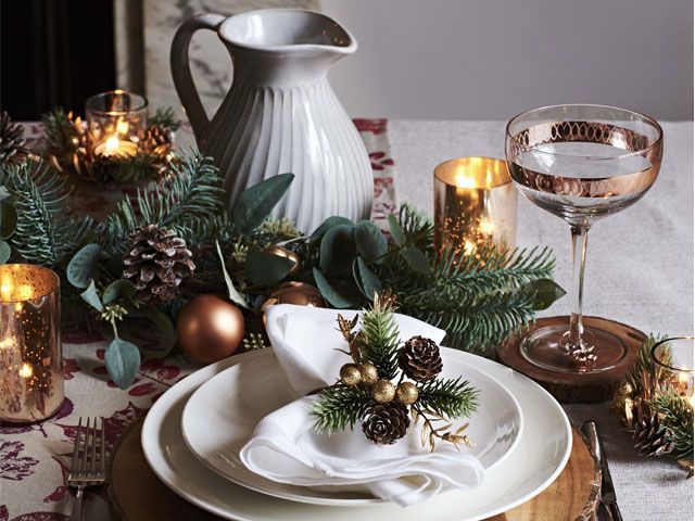 amber and gold-themed Christmas dining table setting with white plates, jug and gold dipped glassware -john-and-lewis-partners-dining-room-goodhomesmagazine.com