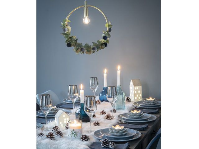Blue and white themed Christmas dining table decor with hanging Christmas wreath -maisons-du-monde-living-room-goodhomesmagazine.com