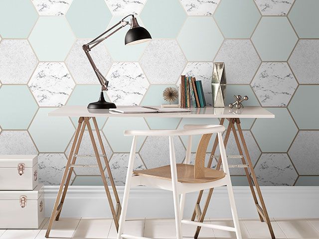Graham and Brown earthen mint geometric print wallpaper in an office space with industrial style desk - wallpaper trends 2019 - goodhomesmagazine.com